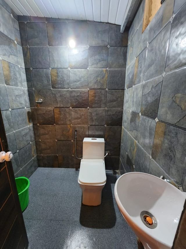 Attached bathroom with slate stone walls